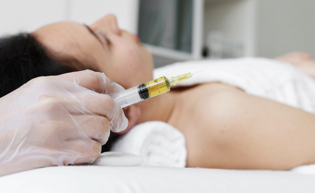 woman having skin booster treatment with syringe fulled with Exosomes